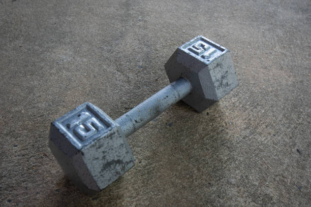 istock A Silver Fifteen Pound Dumbbell on Concrete 1276473031