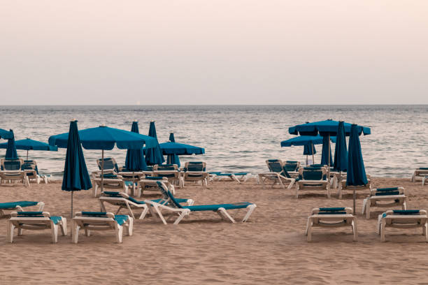 istock empty beach, with hammocks and parasols, cloudy day 1276473137