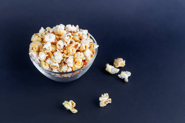 istock A clear bowl of popcorn on the darkened surface. 1276473864