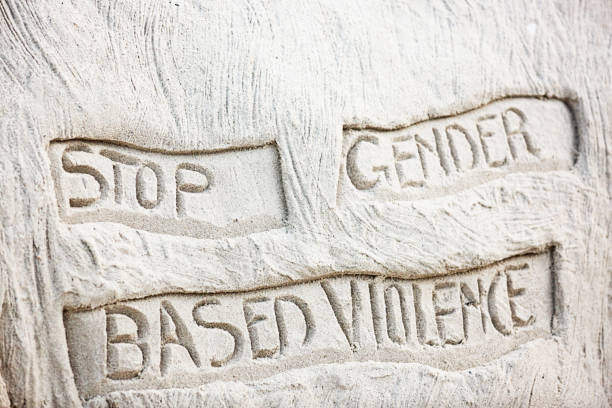 Slogan in sand urges an end to domestic violence.