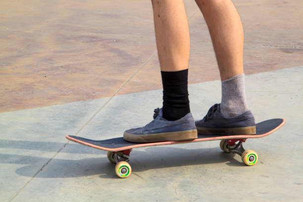 istock Young man practising on skateboard in skate park 1276473920