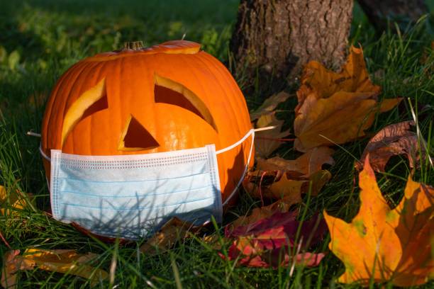 istock Halloween pumpkin with sad eyes wearing mask 1276474121
