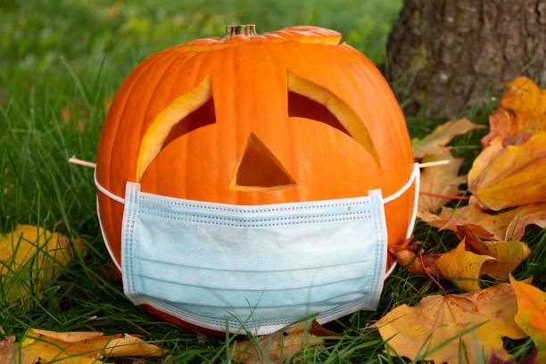 istock Halloween pumpkin with sad eyes wearing mask 1276474123