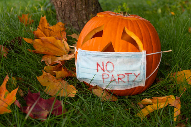 istock Halloween pumpkin with sad eyes wearing mask 1276474129