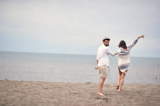 istock Young couple posing on the beach 1276474965