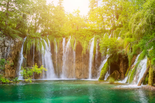 istock crystal clear blue water and waterfall in Plitvice lakes national Park 1276475210