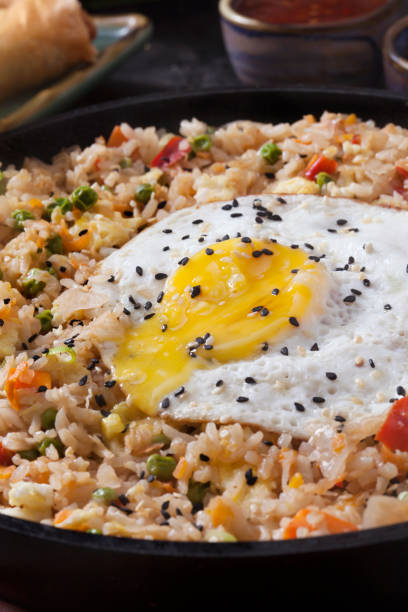 istock Spicy Korean Kimchi Fried Rice with a Fried Egg and Spring Rolls 1276475484