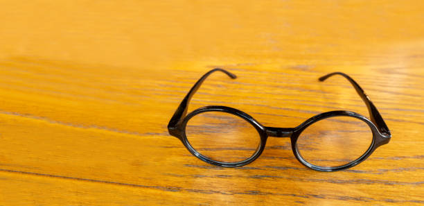 istock eyeglasses on wood background 1276476601