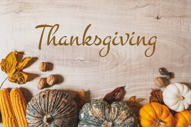 istock Happy Thanksgiving Day with pumpkin and nut on wooden table 1276478885