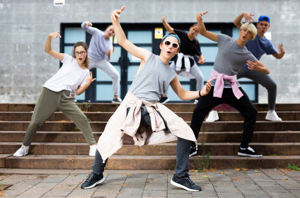 istock Modern teenager performing street dance with group 1276479101