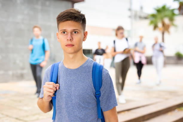 istock Handsome young man going to college down city street 1276479169