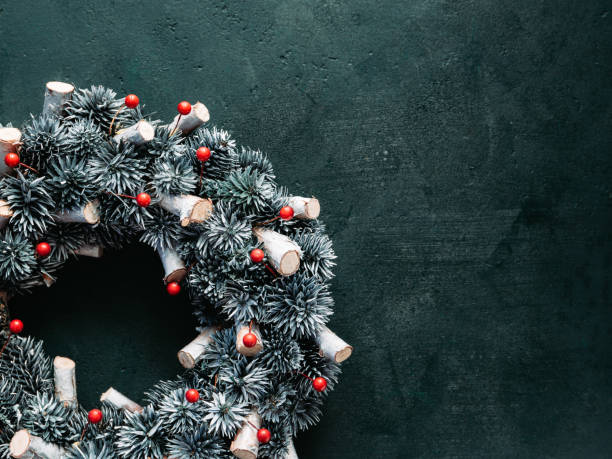 istock Beautiful Christmas wreath over a dark green background. Top view, flat lay, copy space. 1276480072