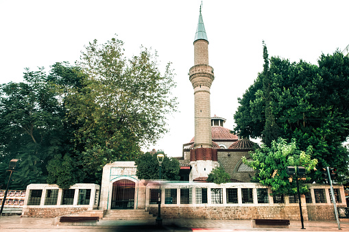 The mosque, located opposite three gates in Antalya. It was taken across the entrance door. It has an architecture that draws attention with its unique distinction. It was taken with a low estantane. Location Antalya  Turkey