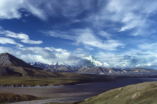 View of  tundra, distant mountains and clouds in Denali National Park.

Taken in Denali National Park, Alaska, USA