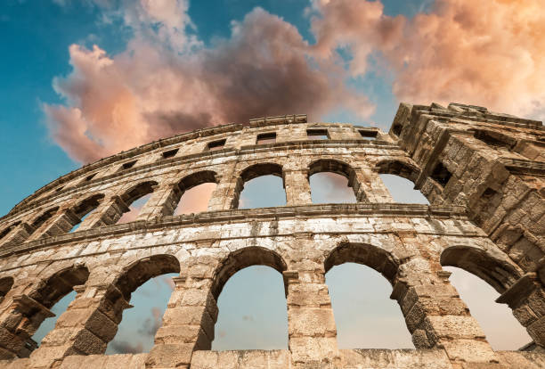 istock Pula, Croatia antique Amphitheatre windows with dramatic sky background. 1276502623
