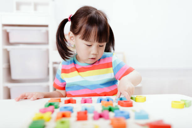 istock young girl learning letter blocks for home schooling 1276504561
