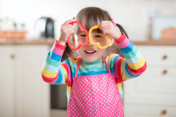 istock young girl put pepper ring on her face as glass against real kitchen background 1276504575