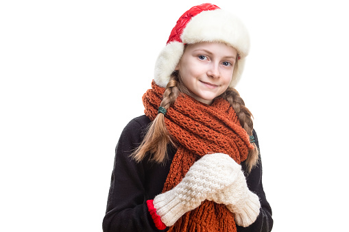 Funny little girl in a Christmas hat. Portrait of a cheerful and happy child.