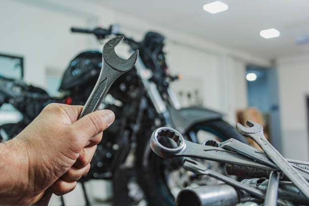 istock Hands of mechanic holding a wrench in workshop, professional tools, selective focus. 1276506272