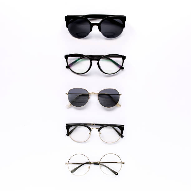 Female sunglasses on white background. Flat lay, top view