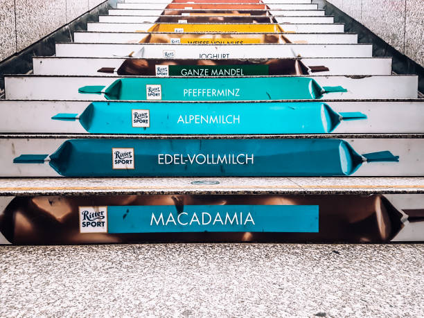Cologne / Germany - 2018: Creative Rittersport chocolate stairs advertisement at a Cologne train station. Unique design of painted steps at German underground public transportation. Ritter Sport ad.