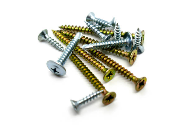 A set of various chromed screws isolated on white background stock photo