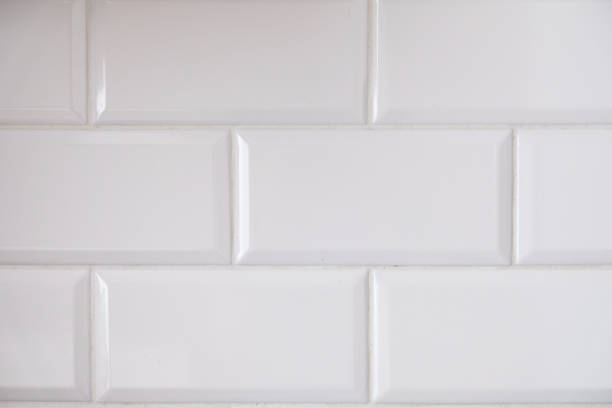 istock Close up view of white tiled kitchen wall. 1276509377