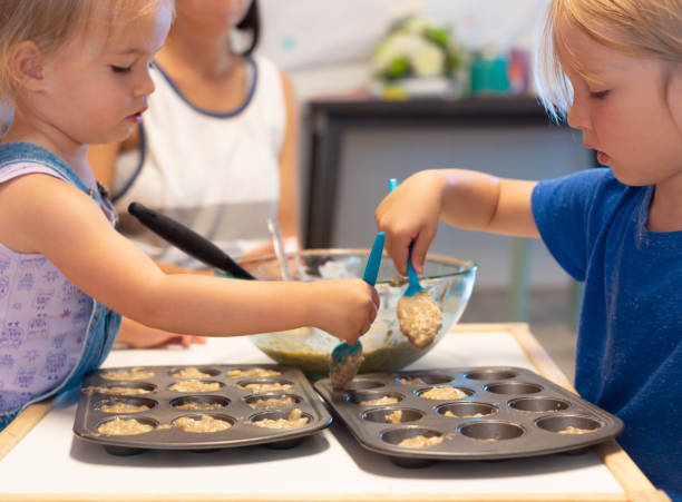 istock Children learning in the kitchen. Baking cooking class at home. 1276510516