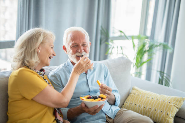 istock Senior couple eating a fruit salad together. 1276512513