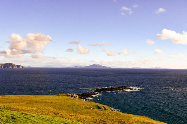 Clare Island seen in the distance off Ireland's Atlantic coast from a cliff-top on Achill, Ireland's biggest island