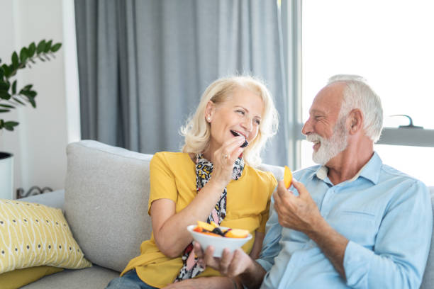 istock Senior couple eating a fruit salad together. 1276512721