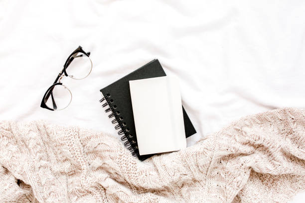 istock Home office on bed with warm plaid. Mockup card. Flat lay, top view 1276518459