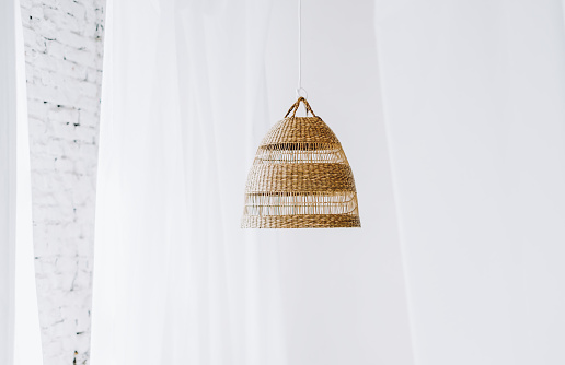 Straw lampshade in bedroom. Eco-friendly design details of bedroom using natural materials. High quality photo