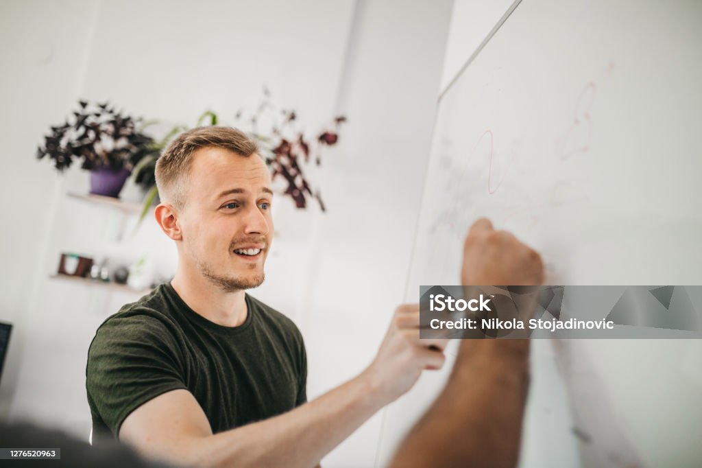 A businessman uses a whiteboard Scrum - Sport Stock Photo