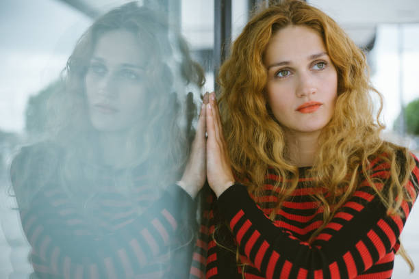 istock beautiful red haired girl and her symmetrical reflection 1276521045