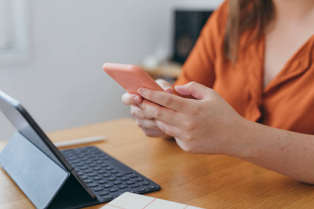 istock Anonymous Woman Using her Smartphone to Surf the Internet at Home 1276522894