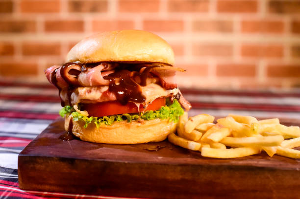 istock hamburger sandwich with brioche bread cream cheese fries bacon sauces on table on blurred background 1276523055