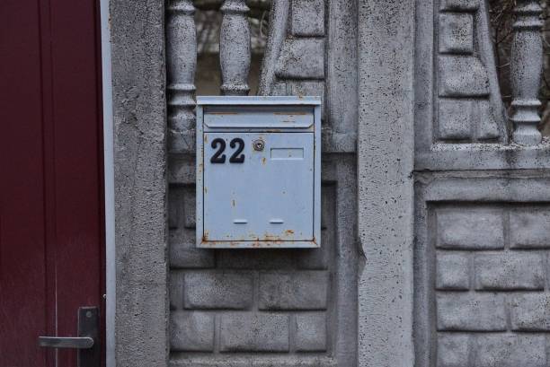 istock one gray metal mailbox with number 22 on a concrete wall 1276523212