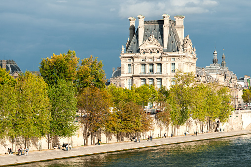 The Louvre facade and quai de Seine in Paris.  Paris, France - September 6, 2020