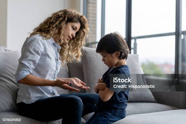 Boy Having A Tantrum At Home And Mother Trying To Talk To Him Stock Photo - Download Image Now