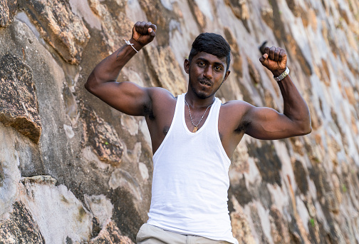 Sri Lankan man is posing in the front of the ancient fortress in Galle, Sri Lanka