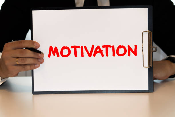 istock man holds the word motivation 1276530033