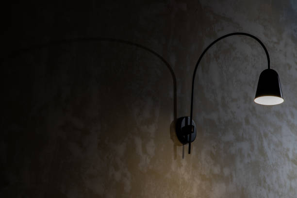 istock Black lamp on grunge concrete cement wall in loft style. 1276533961