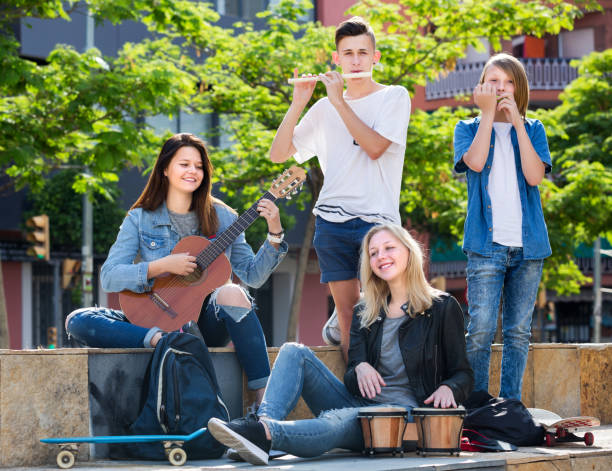istock Teenagers friends playing musical instruments 1276539911