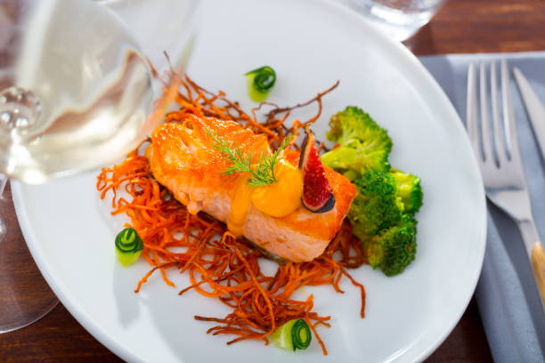 istock Fried salmon with smoked julienne carrot, broccoli, cucumber, figs 1276540006