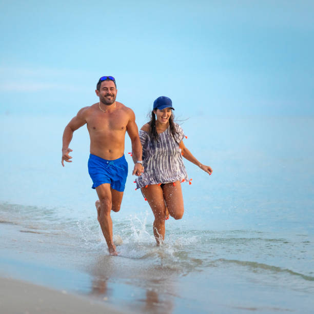 istock Cuban couple running on Naples beach 1276540094