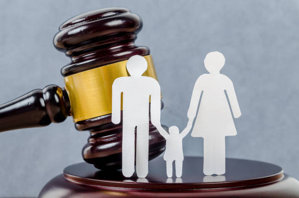istock Family figure and gavel on table. 1276548719