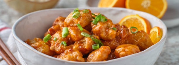 istock bowl of chinese orange chicken on table top 1276549264
