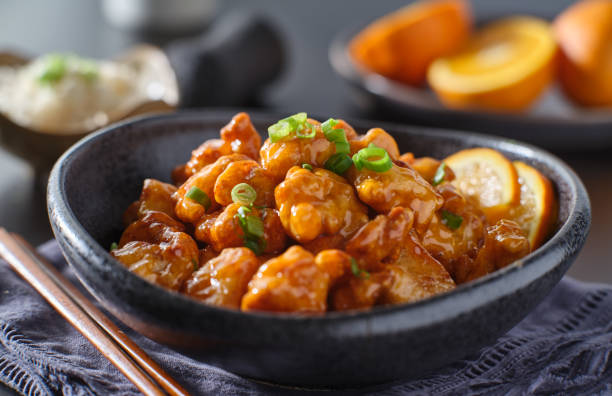 istock bowl of chinese orange chicken on table top 1276549267