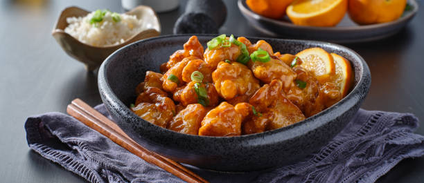 istock bowl of chinese orange chicken on table top 1276549280